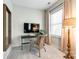A charming office space featuring a wicker chair, natural light, and a dedicated workspace at 405 Five Leaf Ln, Waxhaw, NC 28173