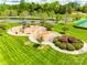 Aerial view of a community playground area with slides, swings, and play equipment on well manicured lawn at 405 Five Leaf Ln, Waxhaw, NC 28173