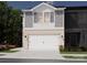 Charming two-story townhome with brick accents, an attached garage, and manicured landscaping at 4301 Summit Woods Dr, Charlotte, NC 28216