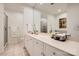 Spacious bathroom with a double sink vanity, large mirror, and tile flooring at 435 S Tryon St, Charlotte, NC 28202