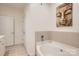 Bright bathroom with a soaking tub, neutral tile surround, and modern fixtures at 435 S Tryon St, Charlotte, NC 28202