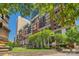 Beautiful condominium building showcasing brick facade, balconies, landscaping, and the vibrant city skyline at 435 S Tryon St, Charlotte, NC 28202