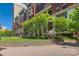 Beautiful community park adjacent to residential building with green spaces, landscaping and sculpture at 435 S Tryon St, Charlotte, NC 28202
