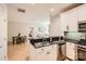 Well-lit kitchen boasts stainless steel appliances, granite countertops, and a view into the dining and living areas at 435 S Tryon St, Charlotte, NC 28202