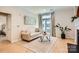 Living room with hardwood floors, a comfortable sofa, large window, and stylish interior design elements at 435 S Tryon St, Charlotte, NC 28202