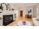Cozy living room with fireplace, hardwood floors, stylish furniture, and dining area near the kitchen at 435 S Tryon St, Charlotte, NC 28202