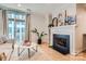 Comfortable living room with modern fireplace, hardwood floors, sofa, and access to outdoor balcony at 435 S Tryon St, Charlotte, NC 28202