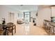 Bright living room with hardwood floors, a cozy sofa, elegant decor, and barstool seating by the kitchen at 435 S Tryon St, Charlotte, NC 28202