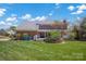 Expansive backyard featuring a brick house, covered patio, lush lawn, and a unique stone garden feature at 4405 3Rd Nw St, Hickory, NC 28601