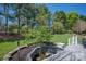 Backyard featuring a wooden deck and a water feature surrounded by trees and greenery at 4405 3Rd Nw St, Hickory, NC 28601