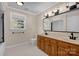 Bathroom with dual sinks, wooden vanity, and large mirror at 4405 3Rd Nw St, Hickory, NC 28601
