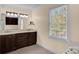Bathroom featuring double vanity, large mirror, and natural light from window, a well-designed space at 4405 3Rd Nw St, Hickory, NC 28601