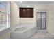 Bright bathroom features a large tub, shower, and dark wood cabinets for ample storage at 4405 3Rd Nw St, Hickory, NC 28601