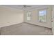 Bedroom with neutral walls, carpet flooring, and two large windows for natural light at 4405 3Rd Nw St, Hickory, NC 28601