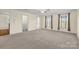 Spacious bedroom with neutral carpet and large windows, creating a bright and airy living space at 4405 3Rd Nw St, Hickory, NC 28601