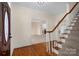 Inviting foyer with hardwood floors, a staircase, and a glimpse into the living room with a fireplace at 4405 3Rd Nw St, Hickory, NC 28601