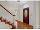 Welcoming foyer featuring hardwood floors, staircase, and decorative front door at 4405 3Rd Nw St, Hickory, NC 28601