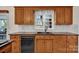 Kitchen with wood cabinets, granite countertops, black appliances, and tiled backsplash at 4405 3Rd Nw St, Hickory, NC 28601