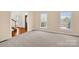 Bright living room featuring neutral carpet with staircase to the left of the frame at 4405 3Rd Nw St, Hickory, NC 28601
