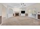 Spacious living room features a brick fireplace, built-in shelving, and neutral carpet at 4405 3Rd Nw St, Hickory, NC 28601