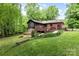 Aerial view of the backyard showing a wood deck, screened-in porch and lush landscaping at 4813 Carving Tree Dr, Mint Hill, NC 28227