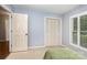 Bedroom featuring a closet with bifold doors and a window with white shutters at 4813 Carving Tree Dr, Mint Hill, NC 28227