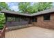 Back exterior featuring a brick house and wood deck with a screened-in porch at 4813 Carving Tree Dr, Mint Hill, NC 28227