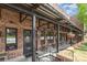 Hawthorne's Pizza patio with brick exterior, metal beams, hanging flower baskets and outdoor seating at 4813 Carving Tree Dr, Mint Hill, NC 28227