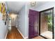 Inviting foyer with wood flooring, purple door, and access to various rooms at 4813 Carving Tree Dr, Mint Hill, NC 28227