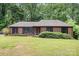 Charming brick ranch-style home with a lush green front yard and dark shutters at 4813 Carving Tree Dr, Mint Hill, NC 28227