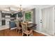 Eat-in kitchen with a wood table and chairs, next to a doorway leading outside at 4813 Carving Tree Dr, Mint Hill, NC 28227