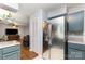 Open kitchen area with stainless steel appliances, updated cabinetry, and laminate wood flooring at 4813 Carving Tree Dr, Mint Hill, NC 28227