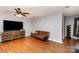 Cozy living room features laminate wood flooring, neutral walls, and natural light at 4813 Carving Tree Dr, Mint Hill, NC 28227