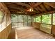 Spacious screened-in porch with wood flooring and ceiling fan at 4813 Carving Tree Dr, Mint Hill, NC 28227