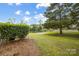 Enjoy a lush backyard with mature trees and tranquil waterfront views at 4816 Spring Lake Dr # B, Charlotte, NC 28212