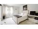 Bright bedroom features a queen bed, large window, and stylish marble-look floors at 4816 Spring Lake Dr # B, Charlotte, NC 28212