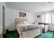 Bright bedroom featuring a queen bed, beach-themed decor, and a cozy sofa at 4816 Spring Lake Dr # B, Charlotte, NC 28212