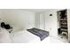 Neutral bedroom features a queen bed and multiple closets and doorways at 4816 Spring Lake Dr # B, Charlotte, NC 28212