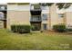 Building's rear exterior featuring patios and balconies, overlooking a well-manicured lawn at 4816 Spring Lake Dr # B, Charlotte, NC 28212