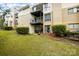 View of the building's exterior with a landscaped lawn, patios, and balconies at 4816 Spring Lake Dr # B, Charlotte, NC 28212