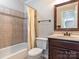A full bathroom featuring a bath tub, tiled walls, and a framed mirror at 5007 Sharon Rd # R, Charlotte, NC 28210