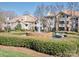 Beautiful condo community featuring lush landscaping, water fountain, and inviting residential buildings on a sunny day at 5007 Sharon Rd # R, Charlotte, NC 28210
