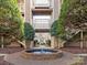 Courtyard with a circular fountain, flanked by well-maintained greenery and condo buildings, creating a peaceful atmosphere at 5007 Sharon Rd # R, Charlotte, NC 28210