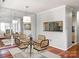 Bright dining area featuring modern chairs, hardwood floors, mirrored wall, and a pass-through to the kitchen at 5007 Sharon Rd # R, Charlotte, NC 28210