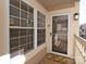 Inviting front porch featuring a storm door, large window, and charming welcome mat for a cozy entrance at 5007 Sharon Rd # R, Charlotte, NC 28210