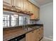A well-lit kitchen with light wood cabinetry, granite countertops, and stainless steel appliances at 5007 Sharon Rd # R, Charlotte, NC 28210