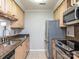 A kitchen featuring light wood cabinets, stainless steel appliances, and granite countertops at 5007 Sharon Rd # R, Charlotte, NC 28210