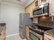 View of kitchen featuring stainless steel appliances, granite countertops, and light wood cabinetry at 5007 Sharon Rd # R, Charlotte, NC 28210