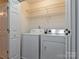 A small laundry room featuring a side-by-side washer and dryer and wire shelves at 5007 Sharon Rd # R, Charlotte, NC 28210