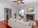 Bright living room with hardwood floors, fireplace, modern furniture, and access to an outdoor balcony at 5007 Sharon Rd # R, Charlotte, NC 28210